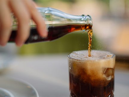 Sentry serves soft drink packaging by moving bottles and cans along the line